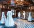 An exhibition of historical white clothing inside a Swiss museum room.